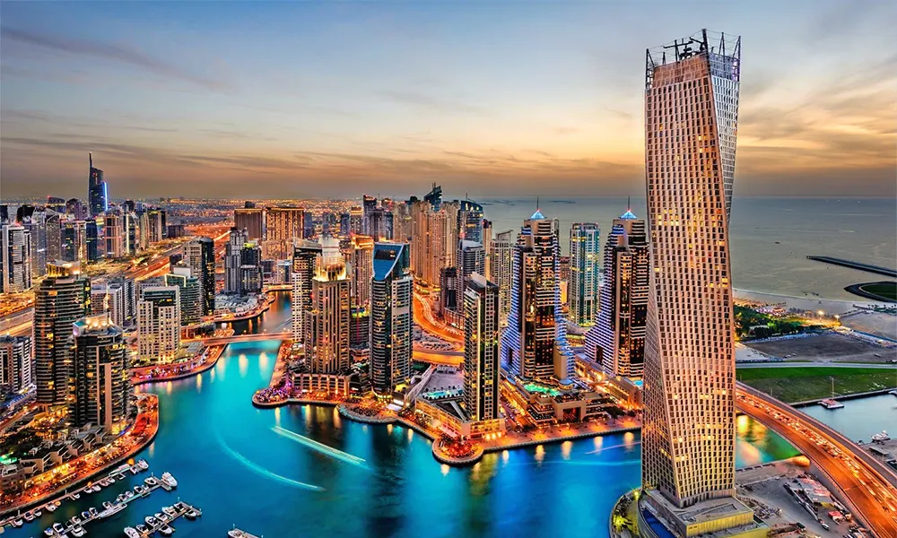The illuminated skyline and marina of Dubai, United Arab Emirates, at dusk.